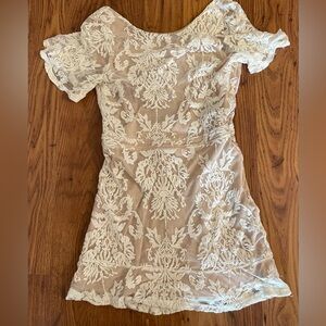 backless lace dress with an ivory floral lace overlay and a beige lining